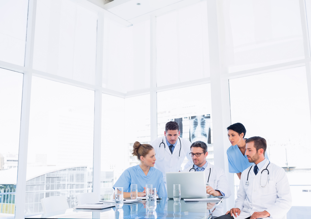 Concentrated medical team using laptop together in the office